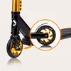 A close-up view of the rear wheel and part of the frame of a black and gold stunt scooter. Anteprima dell’immagine prodotto