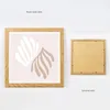 A framed picture is shown from the front and back, displayed against a white background. Produktbild-Vorschau