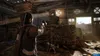 A person aiming a weapon inside a dilapidated wooden structure, with stacks of wood and debris scattered around. Produktbild-Vorschau