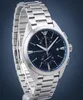 A close-up, studio shot of a men's wristwatch with a blue dial and silver metal band, set against a gradient blue and gray background. Anteprima dell’immagine prodotto