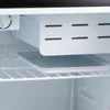 Interior view of a white refrigerator with shelves and a removable tray. Voir les images du produit