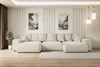 A spacious U-shaped sofa is centrally placed in a modern living room, with artwork on the wall and pendant lights overhead. Produktbild-Vorschau