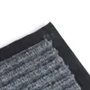 A close-up view of a gray carpet mat with a black backing, shown at an angle. Anteprima dell’immagine prodotto