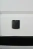 A black CEE power inlet socket with a magnetic closure is mounted on a white surface, with a dark brush strip visible at the bottom. Anteprima dell’immagine prodotto