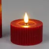 A close-up of a red LED candle with a lit flame. Produktbild-Vorschau
