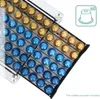 A close-up, angled view of a coffee capsule holder filled with gold and blue capsules. Podgląd zdjęcia produktu