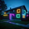 A house decorated with colorful neon lights at night. Produktbild-Vorschau