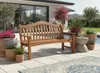 A wooden bench sits on a patio next to a swimming pool, surrounded by potted plants and a rug. Produktbild-Vorschau