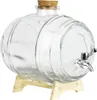 A clear glass barrel-shaped beverage dispenser with a cork stopper and a silver spigot, resting on a light wood stand. Produktbild-Vorschau