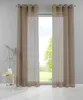 Two sheer taupe curtains hang in front of a window with a view of trees and grass. A small round table with a vase and a book sits to the left. Produktbild-Vorschau