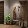 An entryway with a coat rack, bench, and plant. Produktbild-Vorschau
