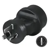 A black travel adapter plug shown from a diagonal angle, with a close-up inset view of the socket. Produktbild-Vorschau