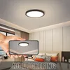 A hand holding a smartphone displaying a reflection of a ceiling light in a bedroom. Náhľad obrázku produktu