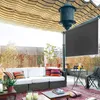 A covered patio with outdoor furniture, including a sofa and table, set up for relaxation. Náhled obrázku produktu