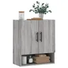 A gray wood-effect wall cabinet with two doors and an open shelf below, decorated with a plant and some toiletries. Produktbild-Vorschau