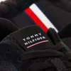 A close-up view of the tongue of a black Tommy Hilfiger sneaker. Náhled obrázku produktu