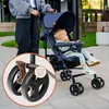 A person pushing a stroller with a baby in it, with a close-up inset of the stroller's wheel. Produktbild-Vorschau
