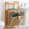 A bamboo shelving unit with a laundry basket in a bathroom setting. Podgląd zdjęcia produktu