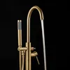 A close-up shot of a gold bathtub faucet with water running. Produktbild-Vorschau