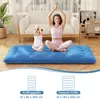 A woman and a child are meditating on a blue mattress in a living room. Produktbild-Vorschau
