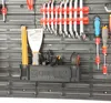 A close-up view of a tool organizer wall with various tools mounted on it. Produktbild-Vorschau