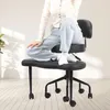 A person is sitting on an ergonomic office chair in a room with light-colored wooden floors and a white wall. Náhľad obrázku produktu