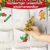 A hand is placing a golden decorative sprig into a pocket of a fabric advent calendar. Produktbild-Vorschau