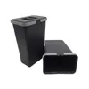 Two black waste bins with gray accents are shown on a white background. One bin is upright, and the other is lying on its side. Voir les images du produit