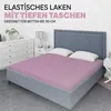 A bedroom scene with a bed featuring a pink fitted sheet. Produktbild-Vorschau