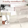 A woman changing a baby on a height-adjustable changing table, with text overlays and diagrams illustrating features. Produktbild-Vorschau