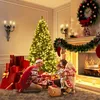 A family opening presents around a Christmas tree. Produktbild-Vorschau