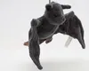 A plush toy bat is hanging against a white background. Produktbild-Vorschau