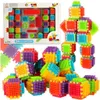 A collection of colorful building blocks, some assembled into a robot figure, and others in a box. Voir les images du produit