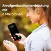 A woman is holding a smartphone and an earbud, with text overlay describing call noise reduction. Produktbild-Vorschau