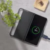 A smartphone case is shown on a charging pad next to a plant and a small dish of paper clips. Voir les images du produit