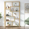 A gold-colored bookshelf with various decorative items and books on its shelves, placed against a white wall. Produktbild-Vorschau