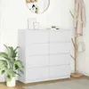 A white dresser with eight drawers is shown in a room with a plant and a coat rack. Anteprima dell’immagine prodotto