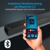 A hand holding a smartphone displaying a music app, with a soundbar in the background. Produktbild-Vorschau