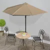 An outdoor patio scene with a table and chairs under a large umbrella. Anteprima dell’immagine prodotto