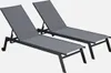 Two grey sun loungers with black frames are shown against a white background.