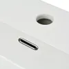 A close-up view of a white ceramic sink with a chrome overflow drain and a circular hole for a faucet. Produktbild-Vorschau