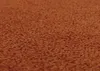 A close-up, textured view of an orange fabric surface, likely a chair seat or cushion. Voir les images du produit