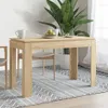 A dining table set up in a room with a plant and chairs. Produktbild-Vorschau