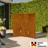 A decorative metal screen with a tree design stands in a garden setting, placed on a paved patio in front of a green hedge. Produktbild-Vorschau