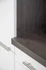 A close-up view of a kitchen cabinet with a dark wood grain shelf and white drawers with silver handles. Produktbild-Vorschau