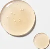 Two drops of a light yellow liquid, one large and one small, on a white background. Náhled obrázku produktu