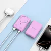 Two pink power banks are shown on a light blue and white striped background, with a white charging case and a smartphone. Náhled obrázku produktu