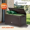 A brown storage box with its lid open, filled with green cushions and pillows, placed on a patio. Podgląd zdjęcia produktu