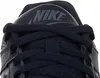 A close-up view of the top of a black Nike sneaker, showing the laces and the Nike logo on the tongue. Voir les images du produit