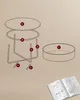 An exploded view of a round coffee table and its components, along with an open instruction manual, all laid out against a plain background. Náhled obrázku produktu